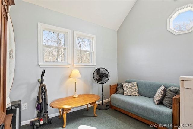 sitting room with baseboards, lofted ceiling, and carpet