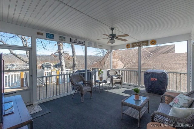 sunroom featuring a ceiling fan and a wealth of natural light