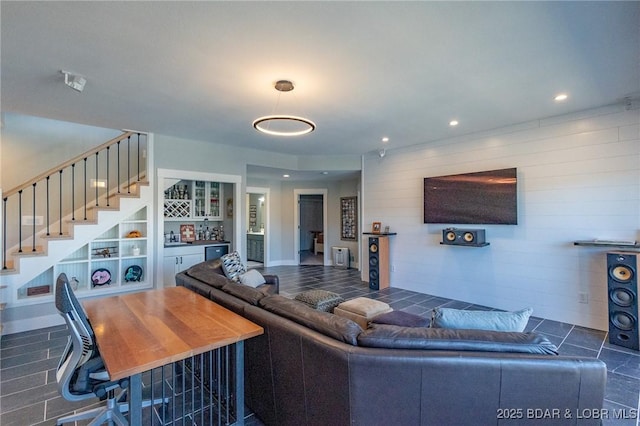 living area featuring stairs, a dry bar, and recessed lighting