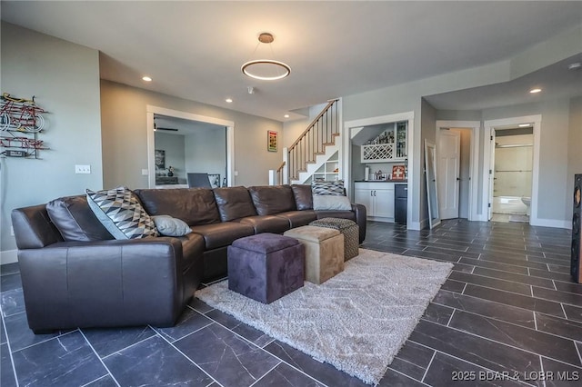 living area with recessed lighting, stairway, baseboards, and a dry bar