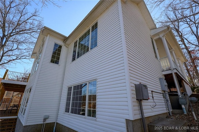 view of side of property with stairs and a deck
