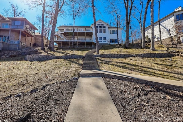 rear view of house featuring a lawn