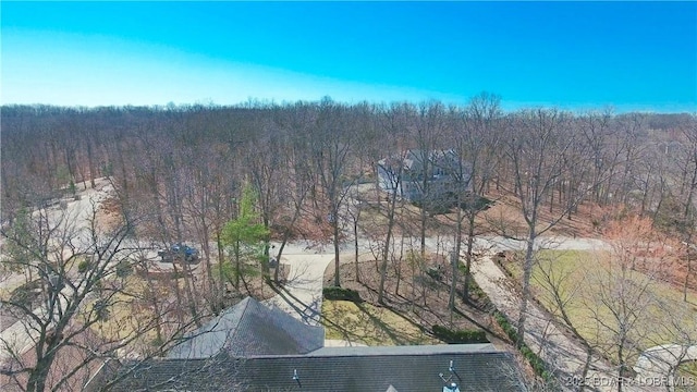drone / aerial view featuring a forest view