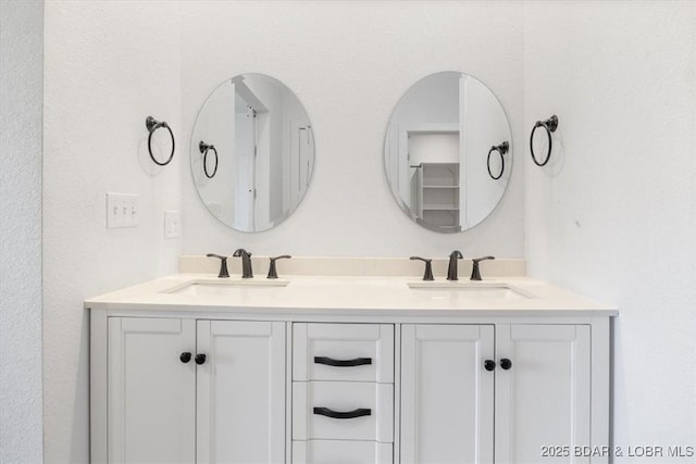 full bathroom with a sink and double vanity