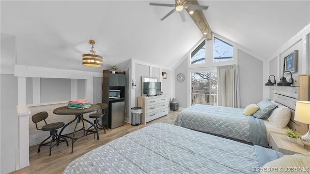 bedroom featuring lofted ceiling with beams, refrigerator, and light wood-style floors