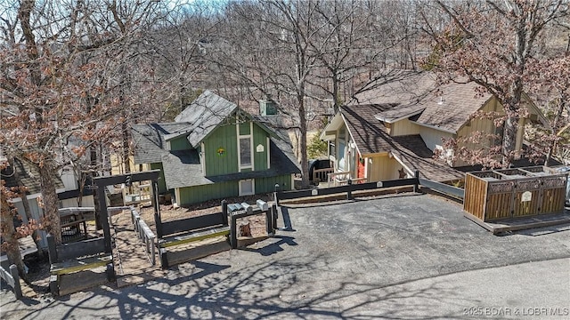 exterior space featuring uncovered parking and a shingled roof