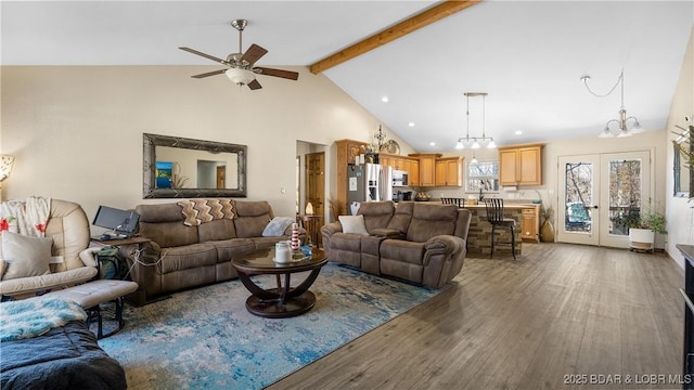 living area featuring beam ceiling, high vaulted ceiling, wood finished floors, french doors, and ceiling fan