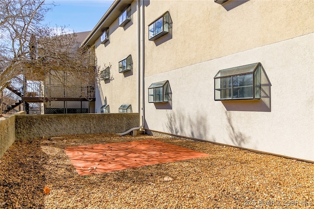 exterior space featuring a patio area and stucco siding