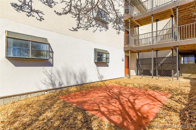 rear view of property with stucco siding and a patio area