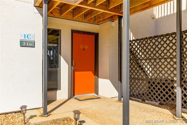 entrance to property with stucco siding