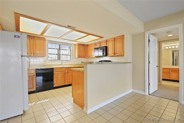 kitchen with light tile patterned flooring, visible vents, black appliances, and light countertops