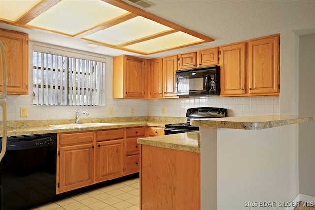 kitchen with black appliances, a sink, backsplash, a peninsula, and light countertops