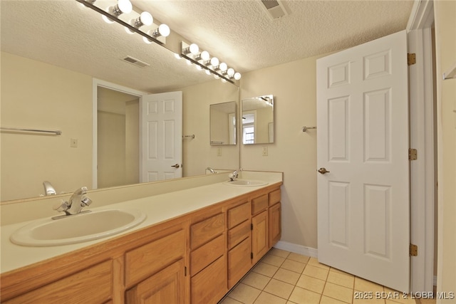 full bath featuring a sink, visible vents, and tile patterned floors