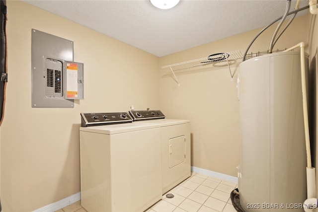 laundry area featuring baseboards, electric panel, laundry area, water heater, and washer and dryer