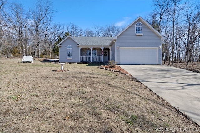 view of front of property with roof with shingles, covered porch, concrete driveway, a front yard, and a garage