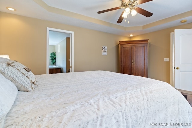 bedroom with recessed lighting, a tray ceiling, and ceiling fan