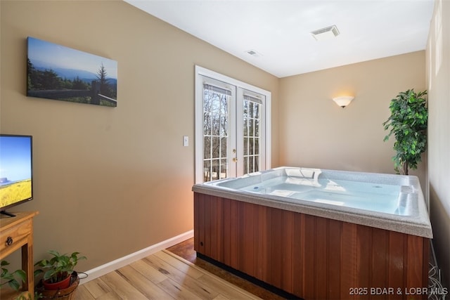 misc room with visible vents, french doors, light wood-type flooring, and baseboards