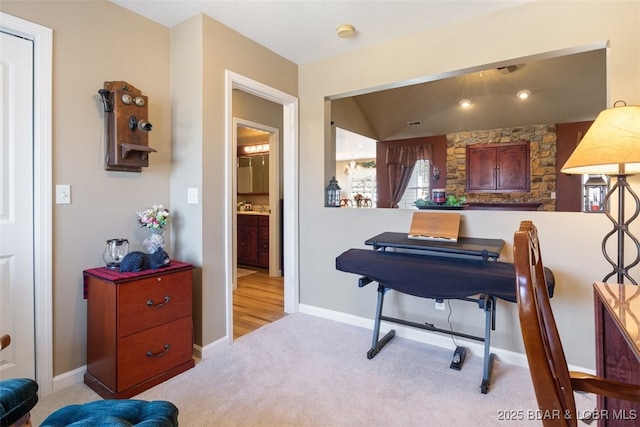 carpeted home office with baseboards