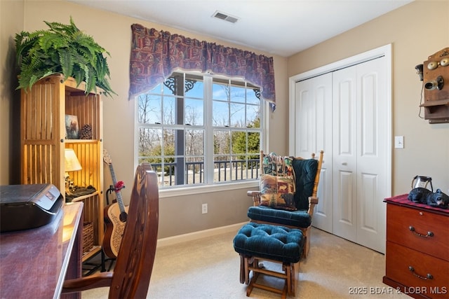 living area with visible vents, baseboards, and carpet flooring