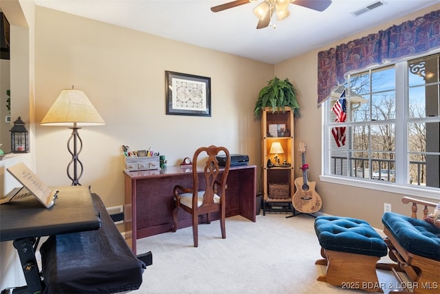 carpeted home office with visible vents and ceiling fan