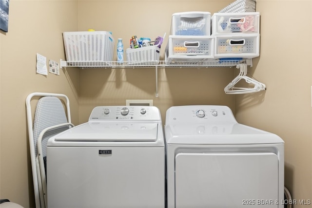 washroom with separate washer and dryer and laundry area