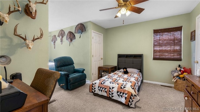 carpeted bedroom featuring visible vents, baseboards, and ceiling fan