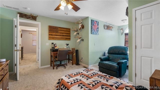 bedroom with visible vents, light colored carpet, baseboards, and ceiling fan