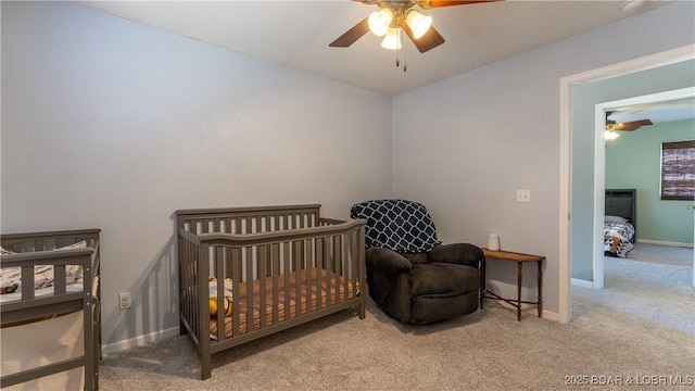 carpeted bedroom featuring baseboards and ceiling fan