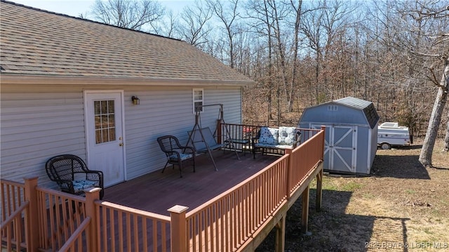 wooden deck with a storage shed and an outdoor structure