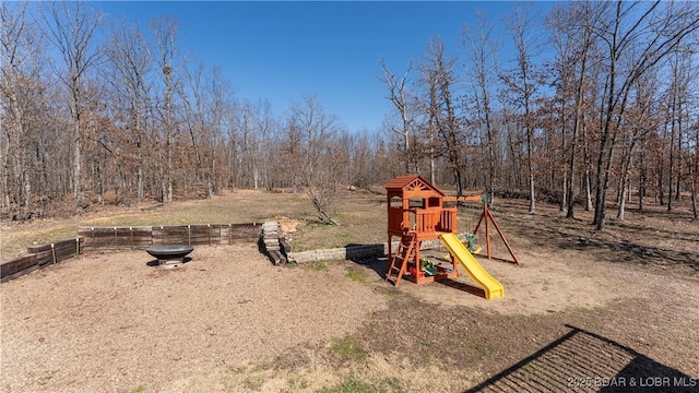 view of playground with an outdoor fire pit