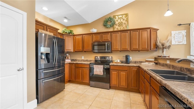 kitchen featuring light tile patterned flooring, a sink, stainless steel appliances, pendant lighting, and brown cabinets