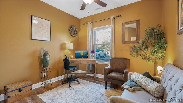 home office featuring ceiling fan, visible vents, baseboards, and wood finished floors