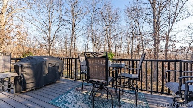 wooden deck featuring outdoor dining area and area for grilling