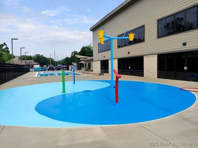 view of home's community featuring a pool, a patio area, and fence