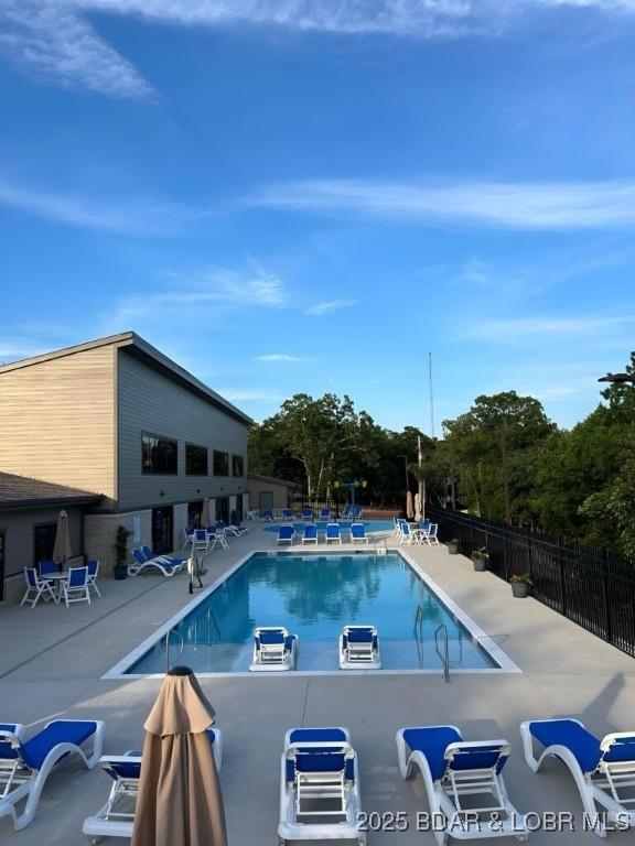 pool featuring a patio and fence