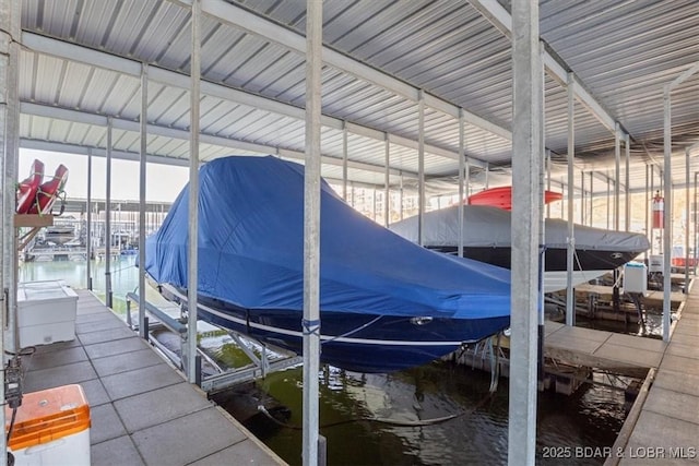 dock area featuring boat lift and a water view