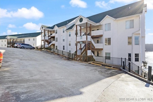 view of property featuring a residential view and uncovered parking