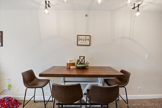 dining space with carpet and baseboards