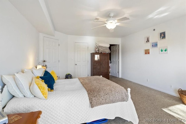 carpeted bedroom with baseboards and a ceiling fan