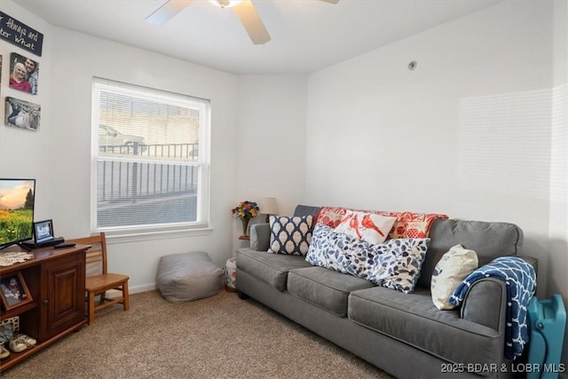 living area with baseboards, carpet, and ceiling fan