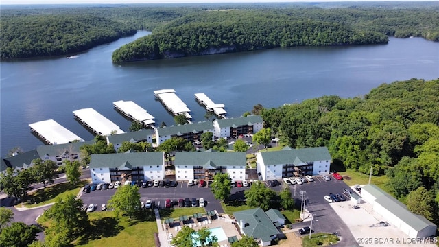 birds eye view of property with a forest view and a water view