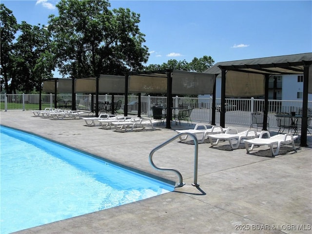 pool with a patio and fence