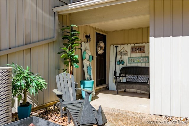 view of exterior entry with board and batten siding