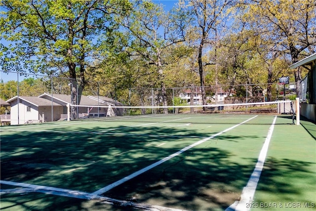 view of tennis court with fence