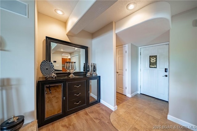 bar with light wood-style flooring, recessed lighting, and baseboards