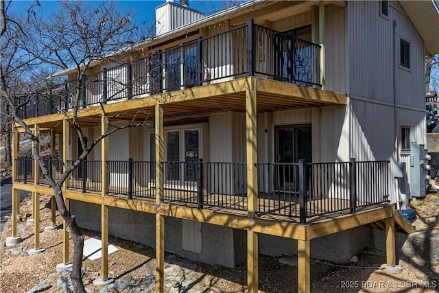 view of property exterior featuring a wooden deck and a chimney