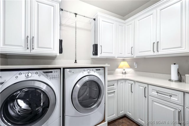 washroom with cabinet space and separate washer and dryer