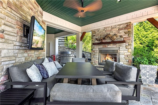 view of patio featuring an outdoor living space with a fireplace