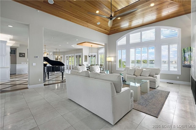 living area with plenty of natural light, wooden ceiling, and baseboards