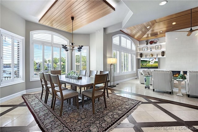 dining space featuring a tiled fireplace, recessed lighting, wood ceiling, and baseboards